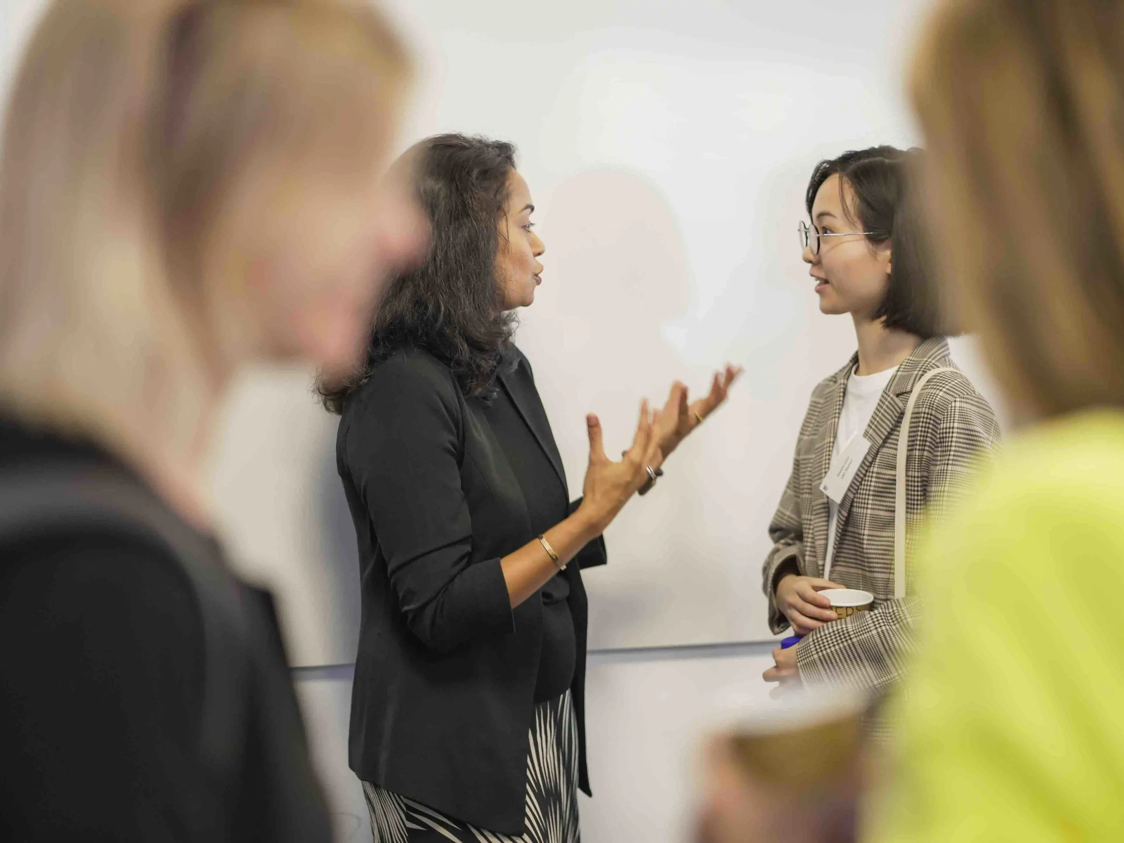 Dr. Poornima Luthra speaking with an audience member at CBS "Building inclusion and belonging in the workplace" event