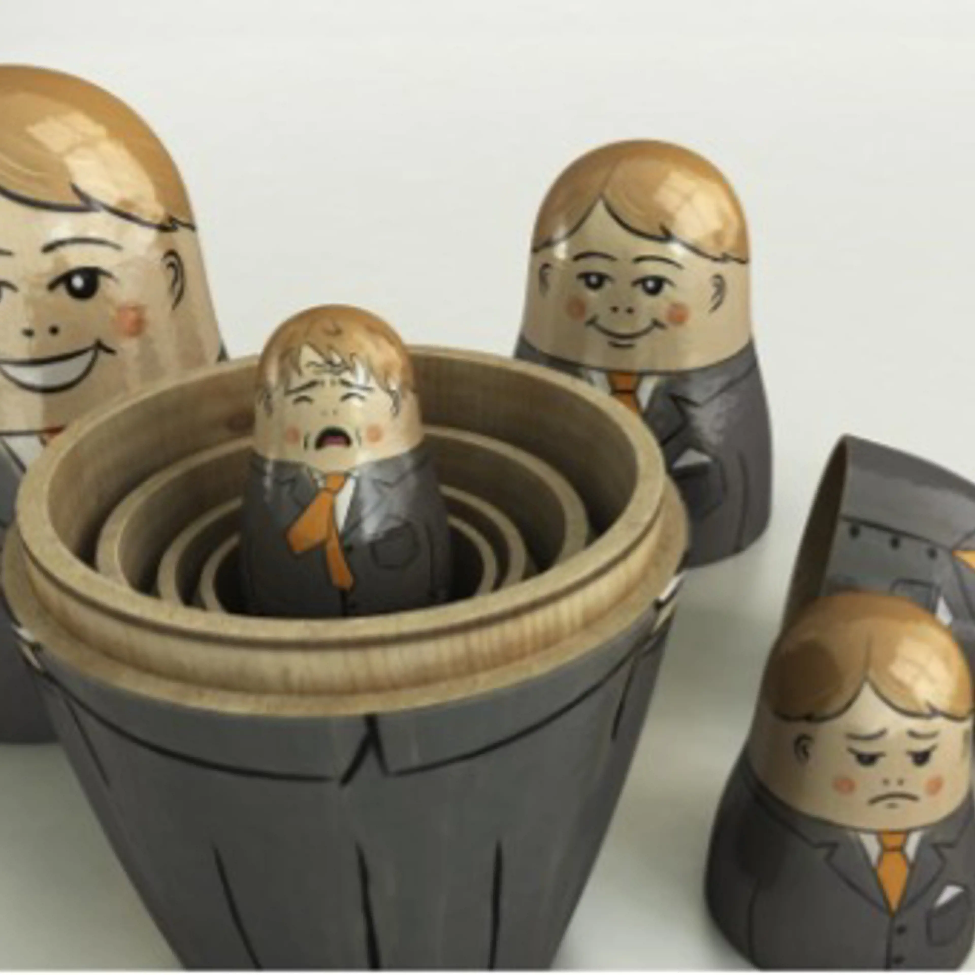 Manager as Russian dolls destacked, with faces changing from the biggest one smiling to the smallest one crying