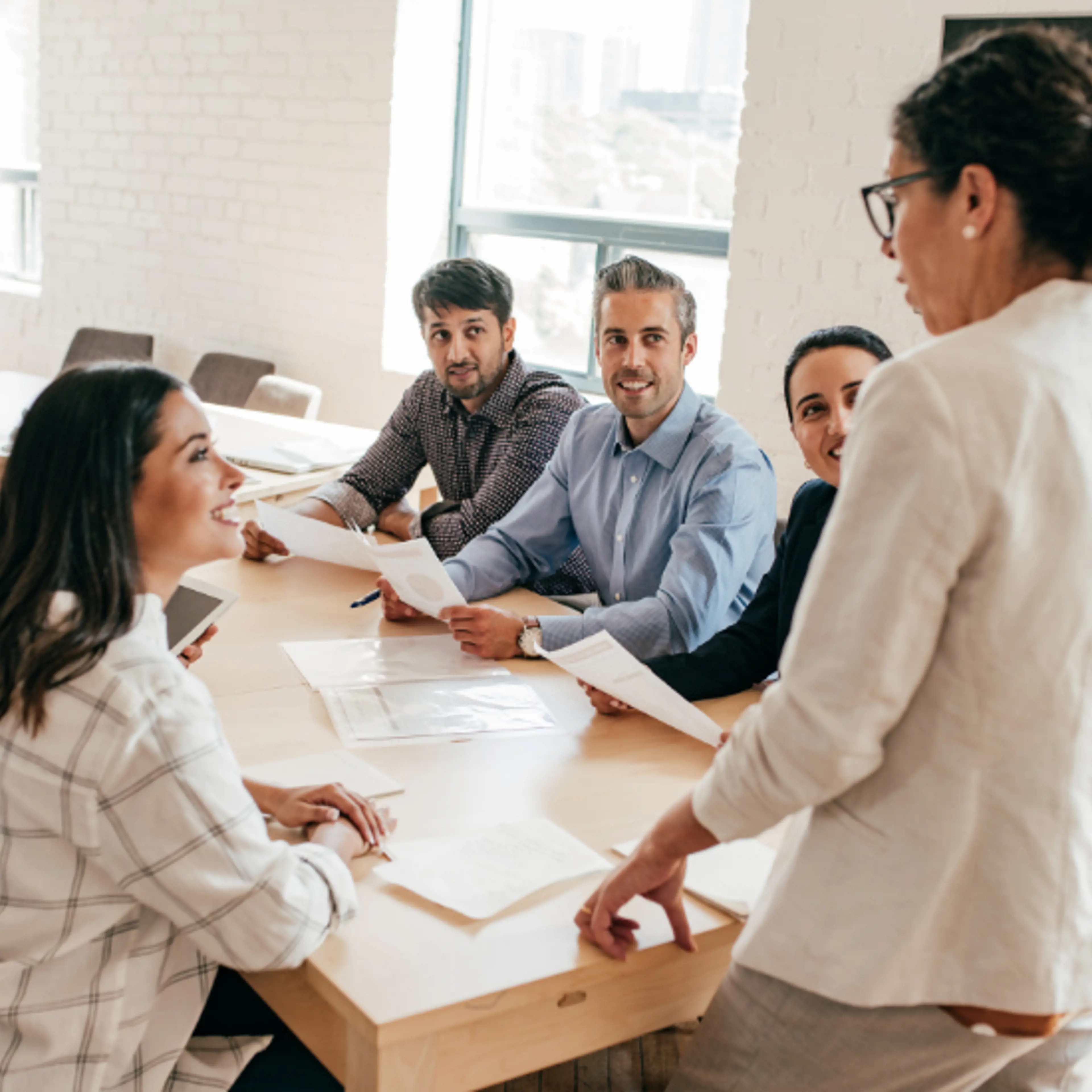 Picture of a team meeting with a female leader