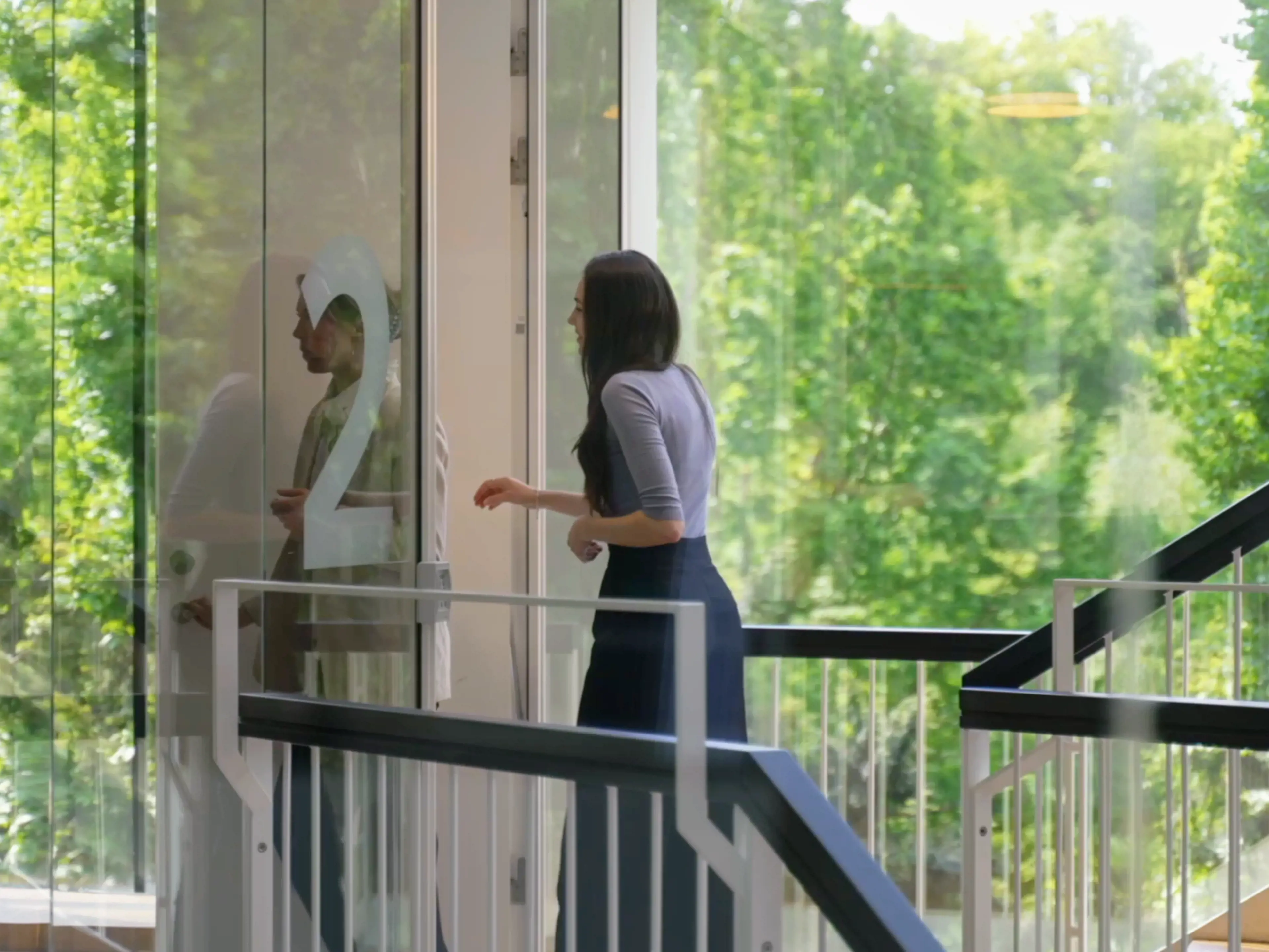 A woman entering the 2nd floor in the CBS MBA building