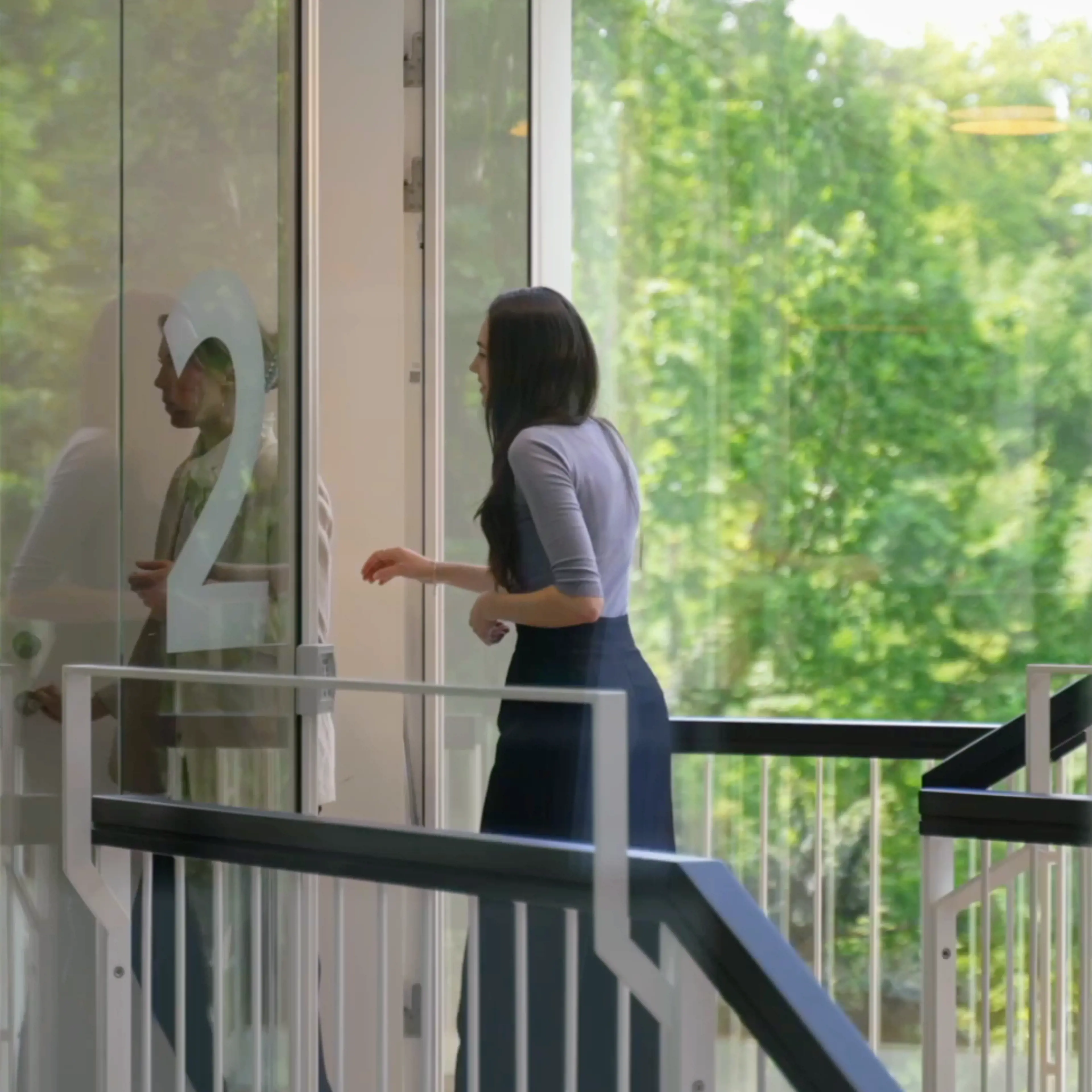A woman entering the 2nd floor in the CBS MBA building