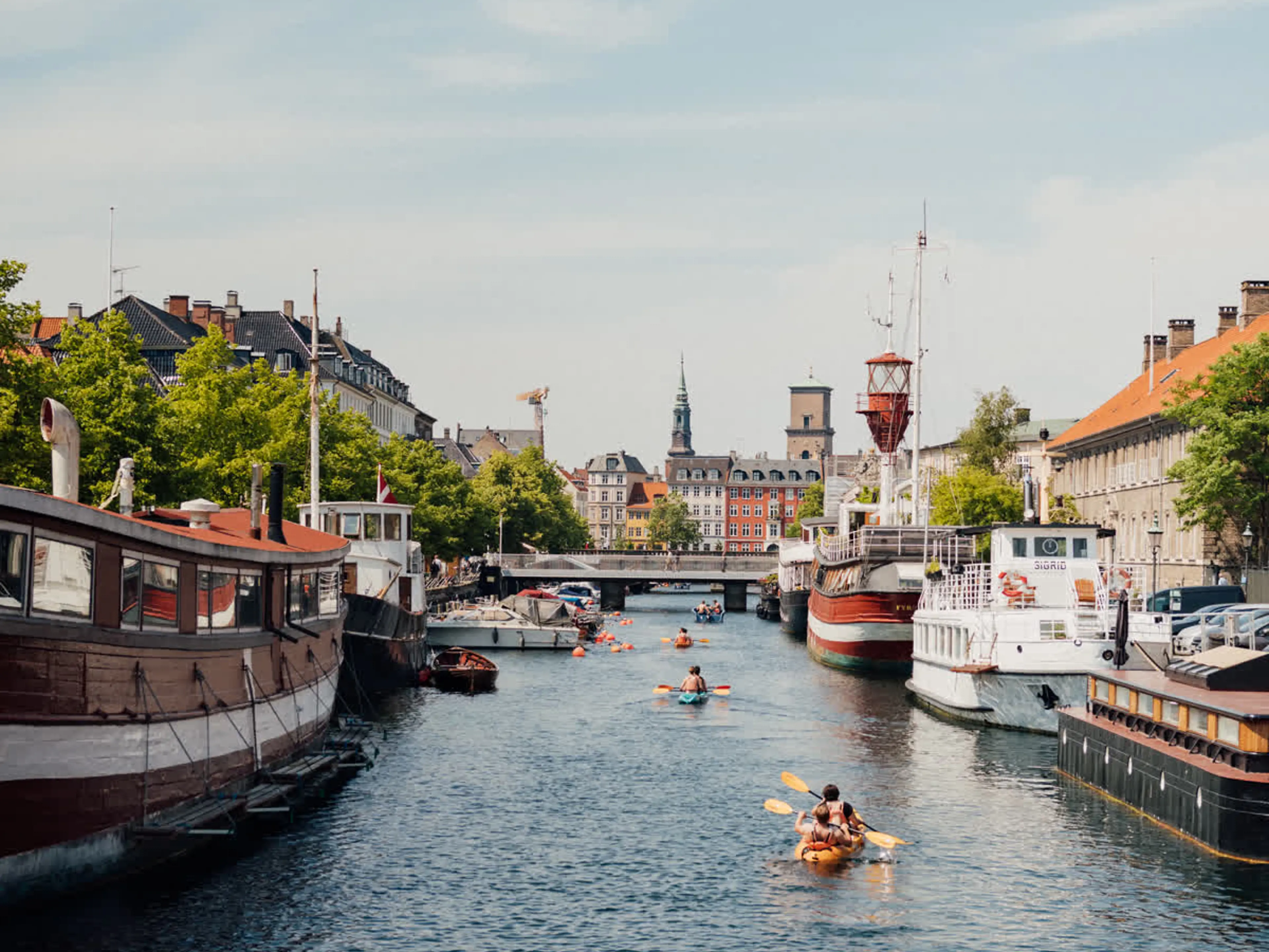 People kayaking on the canals of Copenhagen in summer