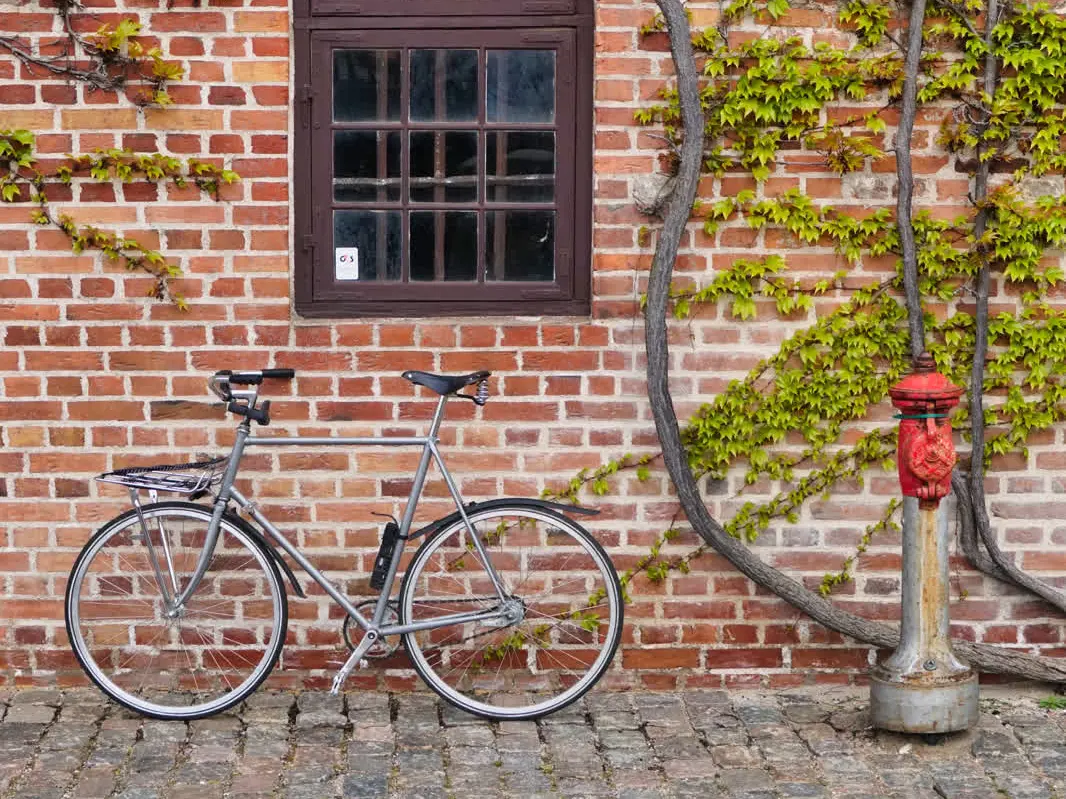 A bike leaning against a brick wall in Copenhagen
