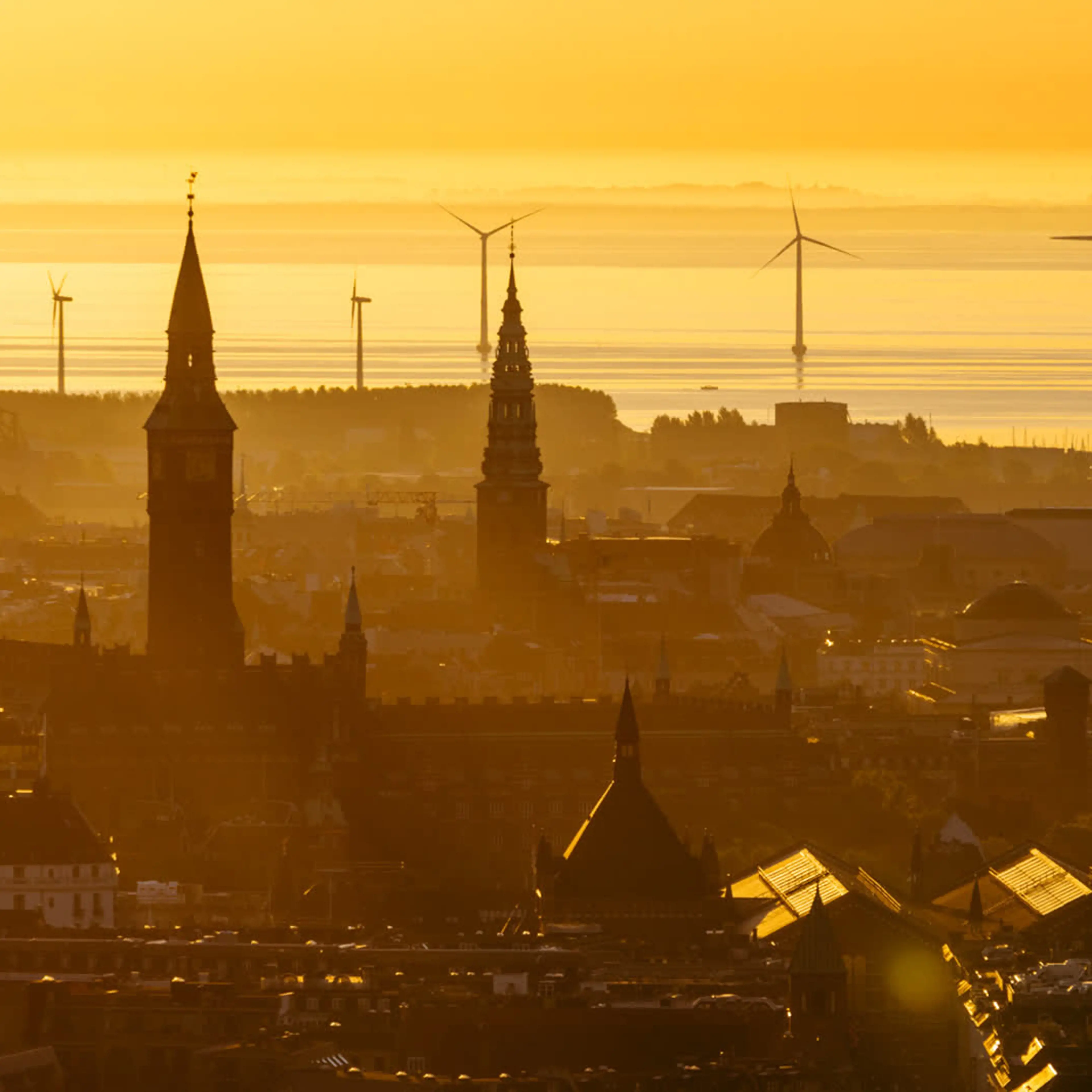 Skyline of Copenhagen at sunset with windmills in the background