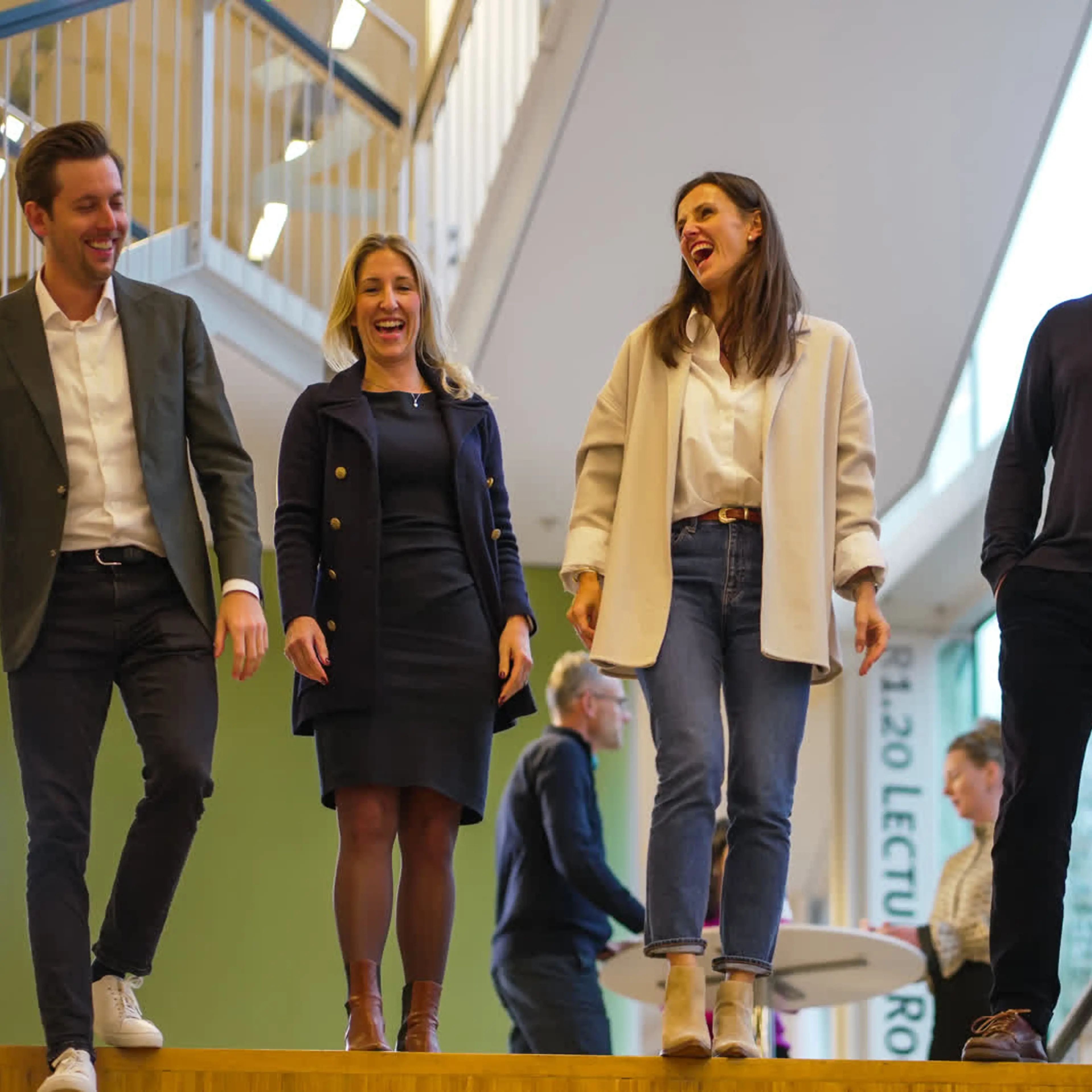 Four CBS Executive MBA participants laughing in the staircase